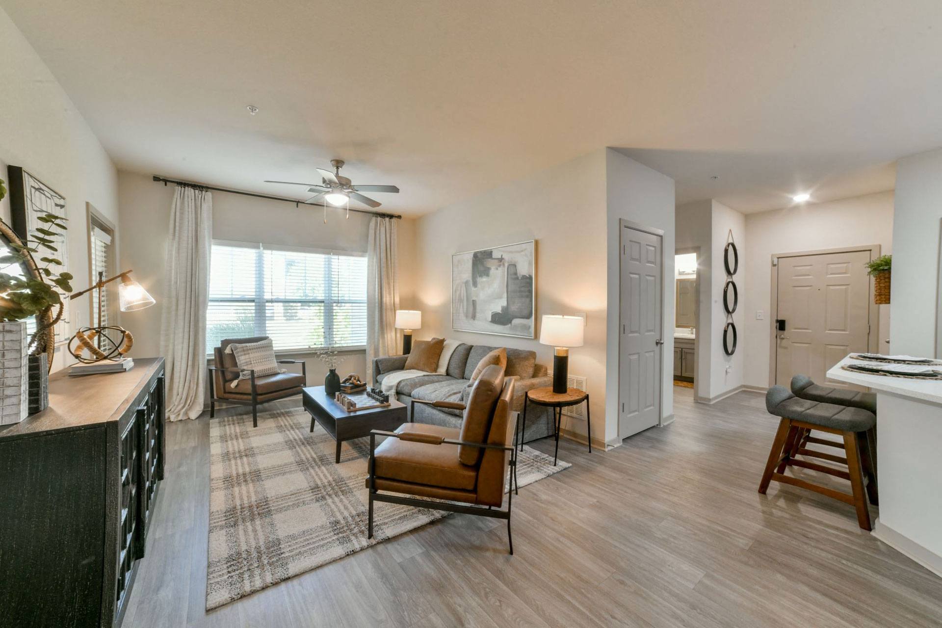 a living room with furniture and a ceiling fan